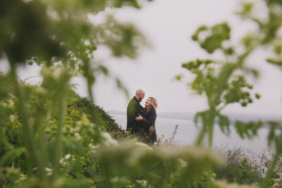 couple near the beach and golden gate bridge